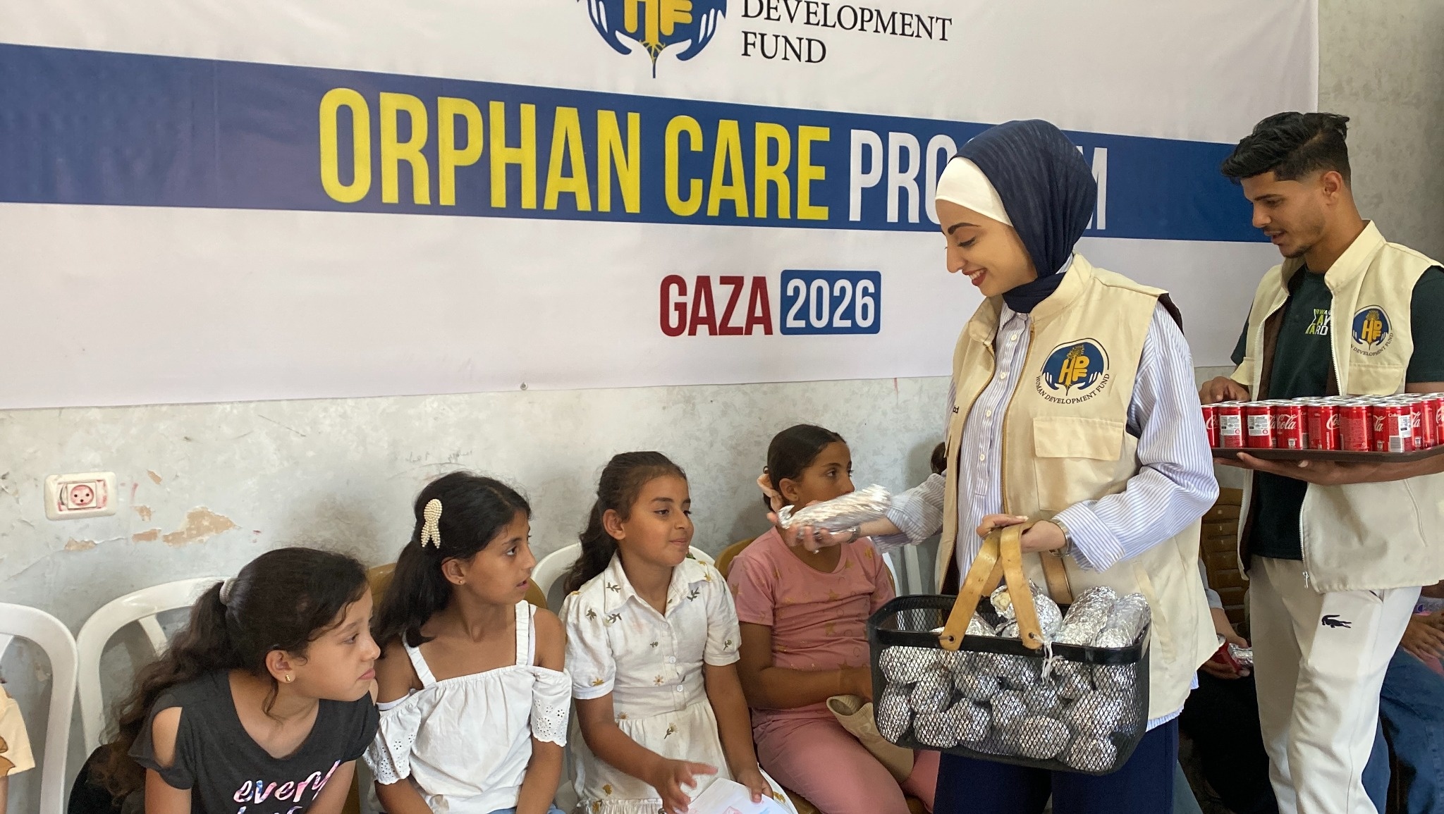 HDF team members serve meals to children at the orphan-care program opening in Gaza